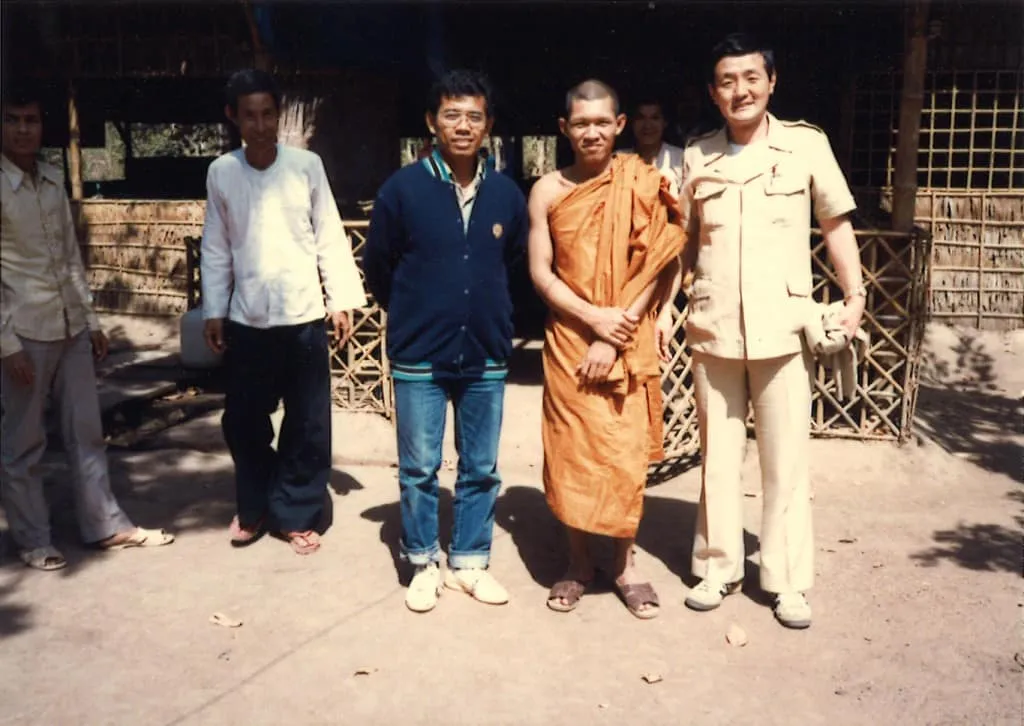 Conducting educational support activities with Buddhist monks in a Cambodian refugee camp